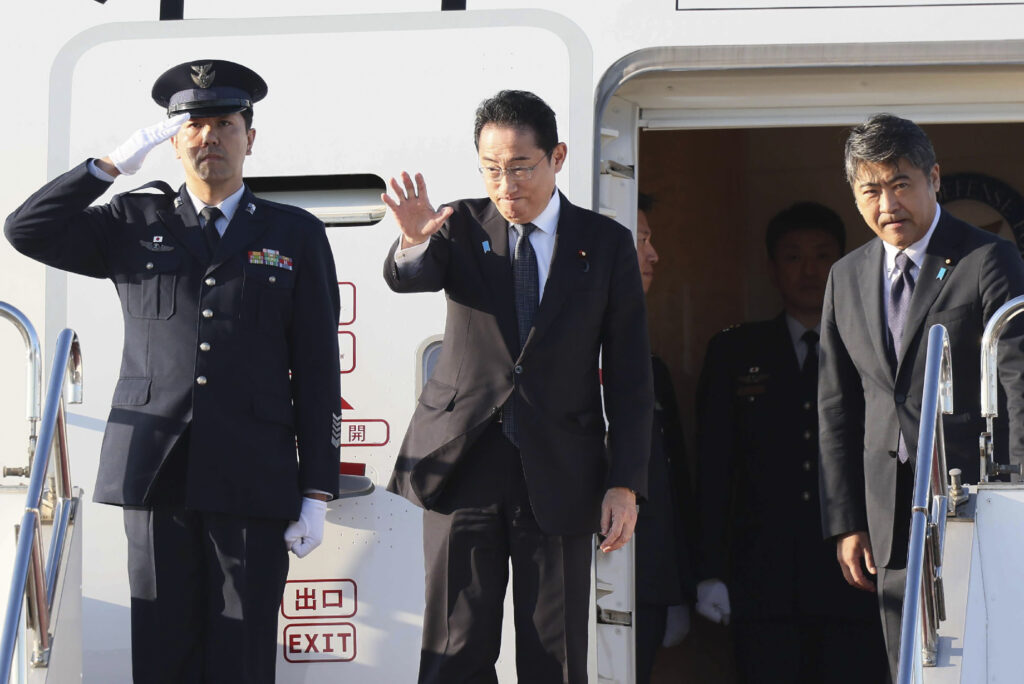 Japan's Prime Minister Fumio Kishida waves before departing for the US for meetings with the US and South Korean leaders. (AFP)