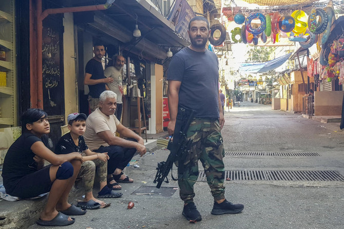 A member of the Fatah group stands guard during a third day of clashes that erupted with Islamist factions in the Palestinian refugee camp of Ein el-Hilweh near the southern port city of Sidon, Lebanon. (AP)