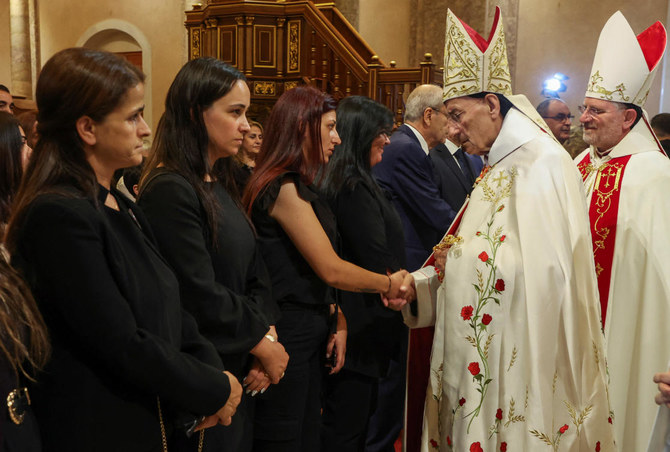 Maronite Patriarch Bechara Boutros Al-Rai holds shakes hands with a family member of one of the victims of August 4, 2020 Beirut port blast, on the eve of the third anniversary of the explosion in Beirut on Aug. 3, 2023. (Reuters)