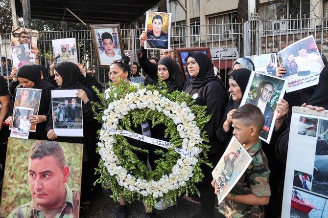 Families of the victims of the 2020 Beirut Port blast demonstrate with their portraits outside the Justice Palace in Beirut on August 4, 2023 on the third anniversary of the deadly explosion. (AFP)