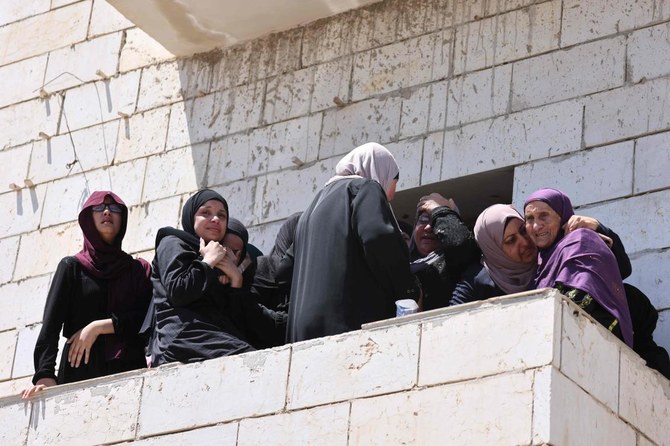 Relatives mourn during the funeral of 19-year-old Palestinian Qusai Jamal Maatan, in the village of Burqa in the north of the occupied West Bank on August 5, 2023. (AFP)