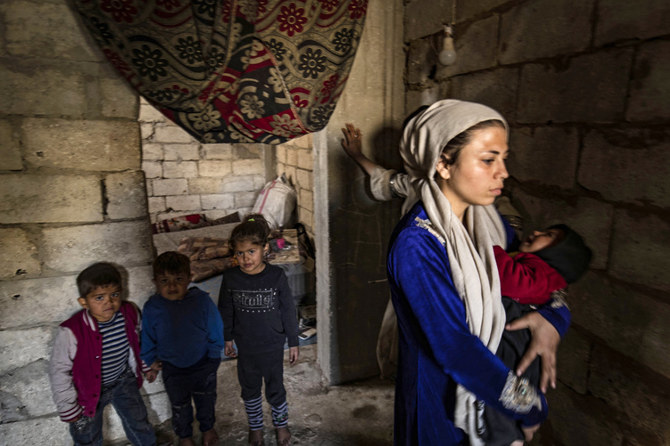 Displaced Syrians living in war-damaged buildings, are pictured in Syria's rebel-held northern city of Raqa on March 1, 2023. (AFP)