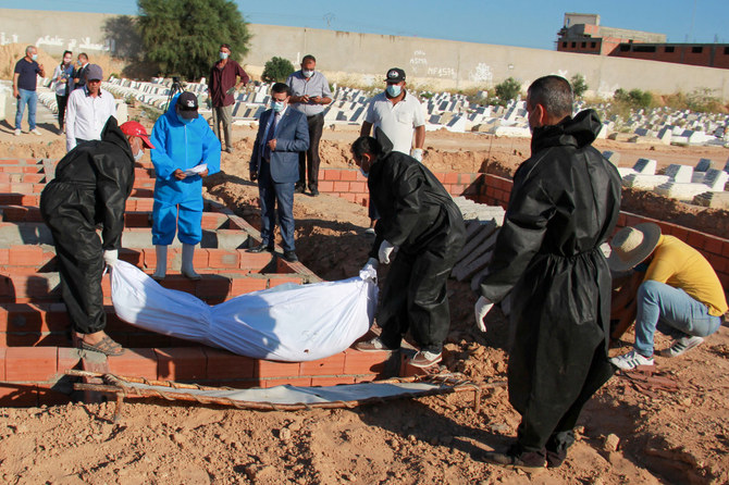 Gravediggers at a cemetery near Tunisia's coastal city of Sfax bury one of the 52 African migrants, who died at sea when their boat capsized near Tunisia's Kerkennah islands, on June 15, 2020. On Aug. 6, 2023, at least four people were found dead and 51 reported missing after another migrant ship sank off Kerkennah. (AFP file)