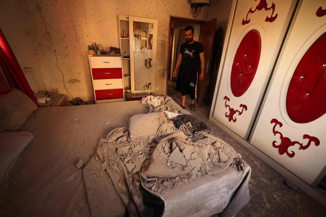 A neighbor inspects a damaged bedroom after Israeli soldiers demolished a house at the Asker camp for Palestinian refugees east of Nablus city in the occupied West Bank, early on August 8, 2023. The Israeli army demolished the house of Abdel Fatah Khroushah accused of an attack which killed two Israelis in the occupied West Bank at the end of February. (AFP)