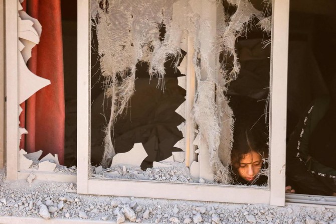 A neighbor inspects a damaged bedroom after Israeli soldiers demolished a house at the Asker camp for Palestinian refugees east of Nablus city in the occupied West Bank, early on August 8, 2023. The Israeli army demolished the house of Abdel Fatah Khroushah accused of an attack which killed two Israelis in the occupied West Bank at the end of February. (AFP)