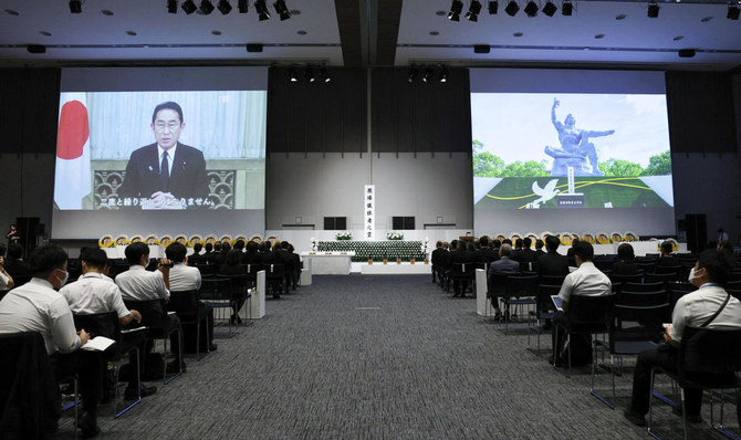 Japan's Prime Minister Kishida and the Peace Statue at Nagasaki Peace Park during a ceremony commemorating the 78th anniversary of the bombing of the city, following a change in venue and scaling down of the ceremony due to Typhoon Khanun approaching. (File/Reuters)