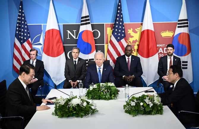 US President Joe Biden (C) sits with South Korea's President Yoon Suk-Yeol (L) and Japan's Prime Minister Fumio Kishida (R) during a trilateral meeting on the sidelines of the NATO summit at the Ifema congress center in Madrid, Spain, on June 29, 2022. (AFP/File photo)