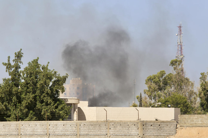 Smoke rises during clashes between rival militias in Tripoli. According to local media, fighting broke out between the 444 brigade and the Special Deterrence Force late Monday evening. (AP)