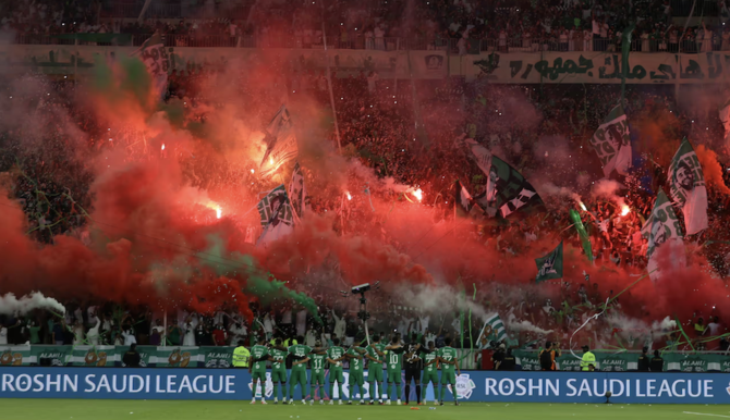 Fans of Al-Ahli show their support before the Saudi Pro League match against Al-Hazm. (AFP)