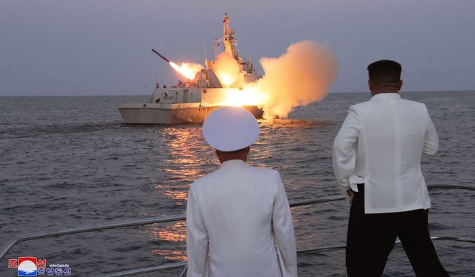 This undated picture released from North Korea's official Korean Central News Agency (KCNA) on August 21, 2023 shows North Korea's leader Kim Jong Un (R) watching a strategic cruise missile being launched from a guard ship marine of the 2nd Surface Ship Squadron of the East Sea fleet, also known as the Sea of Japan, part of a Korean People's naval unit, at an undisclosed location at sea off the coast. (AFP)