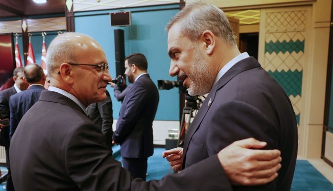 Turkish Treasury and Finance Minister Mehmet Simsek, left, and Turkish Foreign Minister Hakan Fidan at the Presidential Complex, Ankara, Aug. 21, 2023. (AFP)