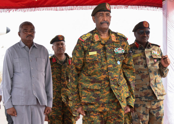 Sudan's General Abdel Fattah al-Burhan listens to the national anthem after landing in the military airport of Port Sudan on his first trip away following the crisis in Sudan's capital Khartoum. (File/Reuters)