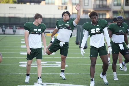 Colorado State defensive lineman Hidetora Hanada (center), is flanked by fellow linemen Whit Powell (left) and Kenyon Agurs as they warm up during the team's NCAA college football practice on the university's campus Tuesday, Aug. 8, 2023, in Fort Collins. (AP)