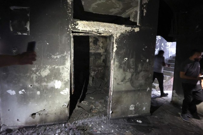 Palestinians inspect the damage following an Israeli military raid at the Balata refugee camp on the outskirts of Nablus in the occupied West Bank early on August 16, 2023. (AFP)