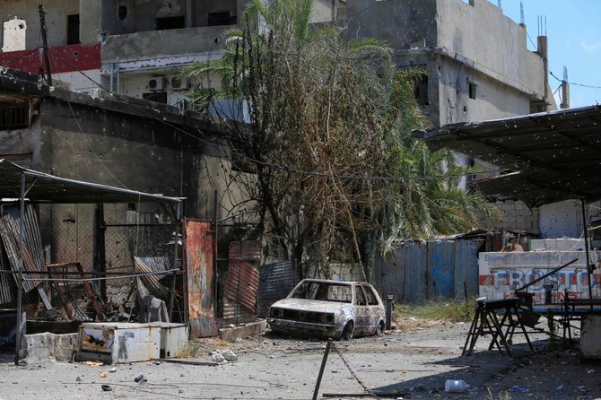 A picture shows a burnt car carcass at the Ain el-Helweh camp in Lebanon’s southern coastal city of Sidon, on August 4, 2023, following the latest flare-up in the camp for Palestinian refugees. (AFP)