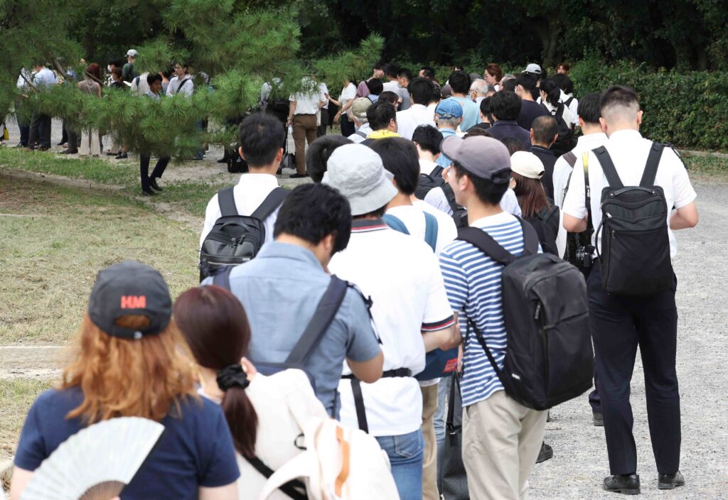 People wait in line for tickets to attend the first trial of Shinji Aoba, the defendant in the Kyoto Animation arson murder case, in Kyoto on September 5, 2023. (AFP)