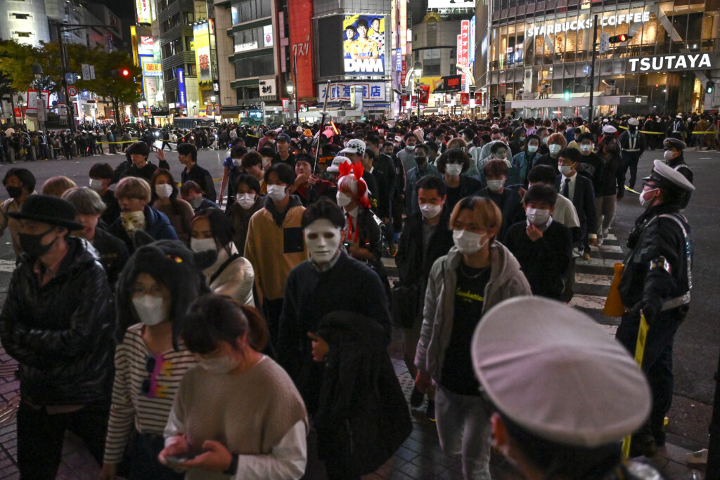 The area around the train station, including the famous scramble crossing, has become a destination for crowds of nighttime Halloween revelers. (AFP)