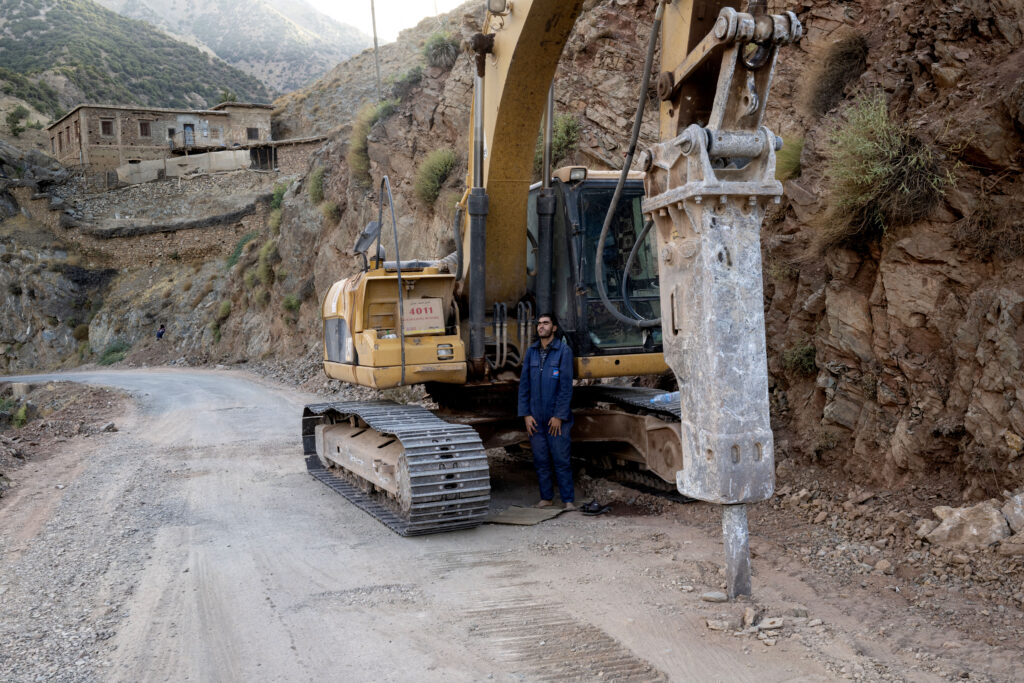 A worker prays in front of his pneumatic drill used in rescue efforts, in the Atlas Mountains range between Maarakesh and Taroudant, on September 14, 2023. (AFP)