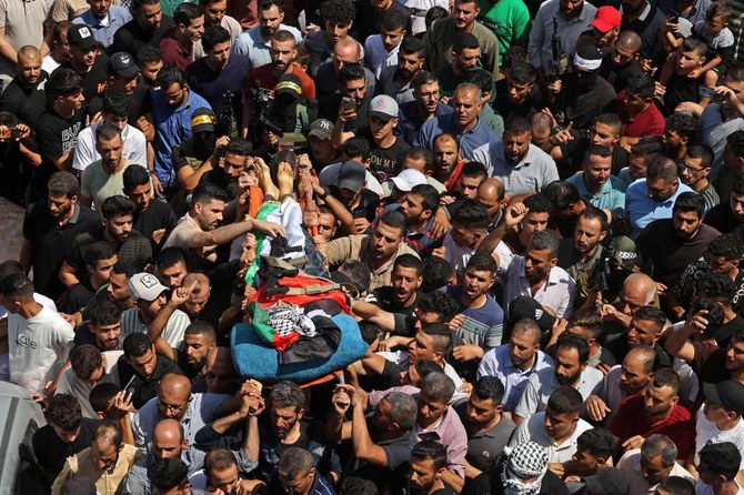 Mourners carry the body of Palestinian AbdulRahim Fayez Ghannam during his funeral in the village of Aqaba in the occupied West Bank. (AFP)