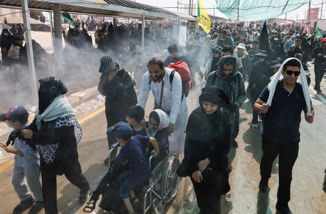 Iranian pilgrims walk on a road past the Zurbatia border crossing between Iran and Iraq, on their way to Kerbala, on August 30, 2023. Iraq's state news agency on Saturday said several Iranians were killed in a road accident in Iraq. (Reuters)