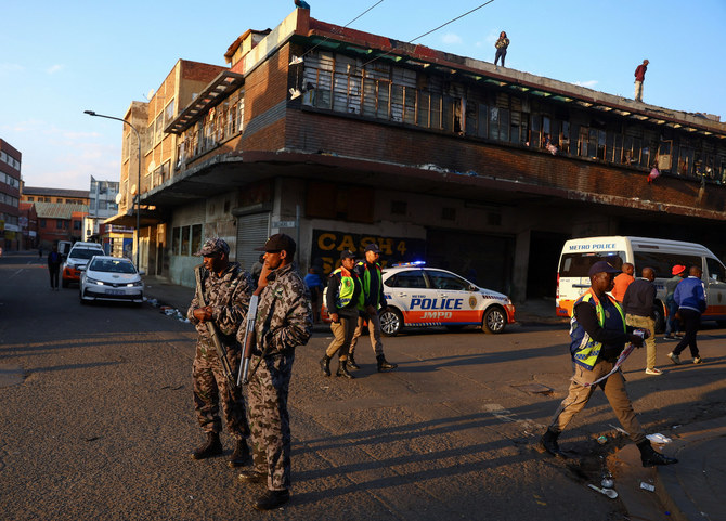 Security personnel keep watch near the scene of a deadly blaze in Johannesburg, South Africa, September 1, 2023. (Reuters)