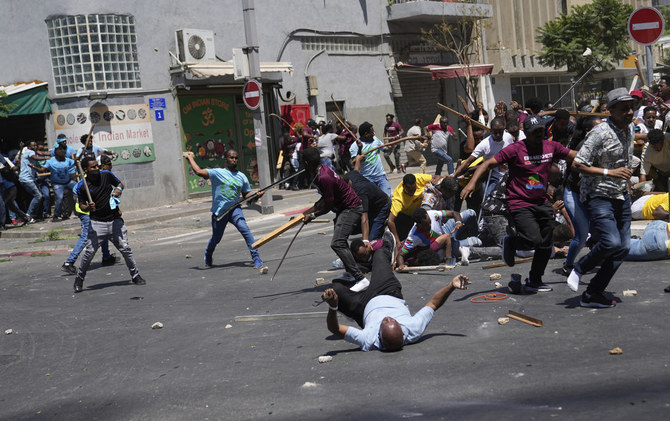 Anti-Eritrean government activists, left, clash with supporters of the Eritrean government, in Tel Aviv on Sept. 2, 2023. (AP)