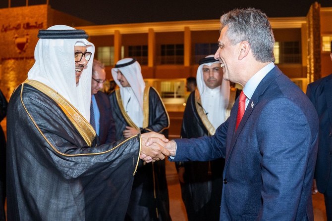 Bahrain’s Foreign Minister Abdullatif bin Rashid Al-Zayani receives his Israeli counterpart Eli Cohen upon his arrival in Manama. (AFP)