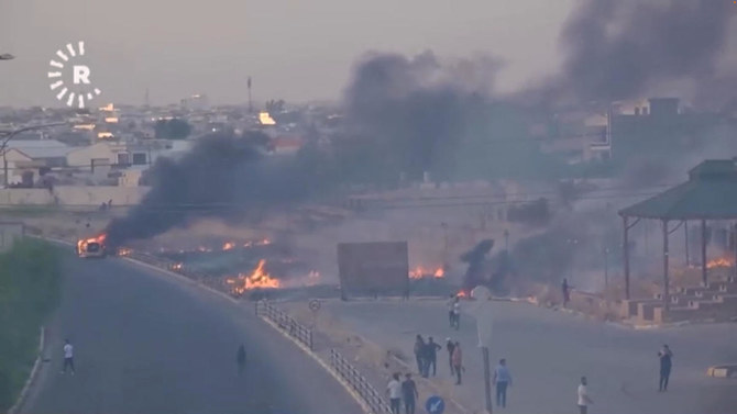 Fires burn as protesters take to the streets during clashes between ethnic groups in Kirkuk (Reuters)