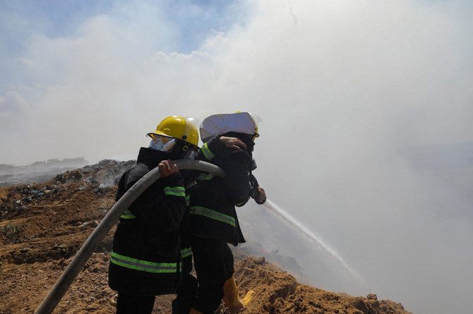A Palestinian extinguishes a fire at a landfill in Juhr al-Deek, southeast of Gaza City, September 3, 2023. (Reuters)