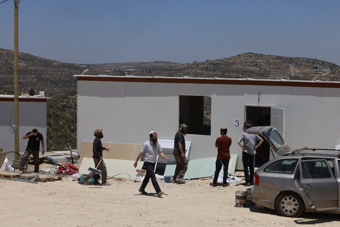 Israeli settlers construct a new outpost near the settlement of Ma'ale Levona, in the occupied West Bank on June 25, 2023. Israel has occupied the West Bank since the 1967 Six-Day War and, excluding annexed East Jerusalem, the territory is now home to around 490,000 Israelis who live in settlements considered illegal under international law. (AFP)