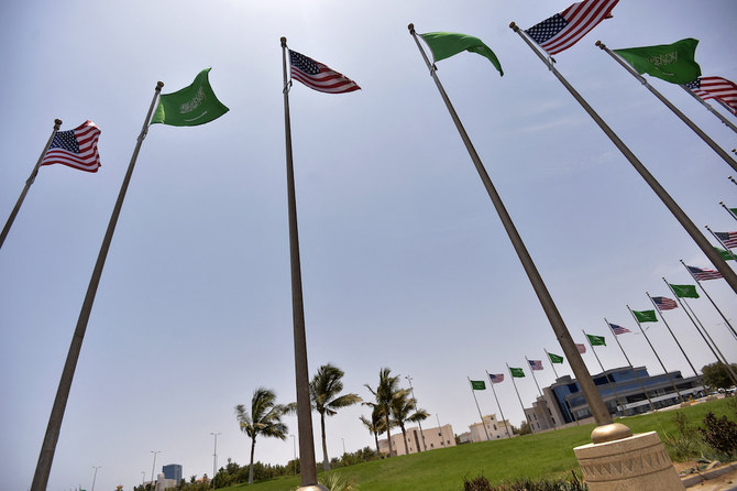 Saudi and US flags line the King Abdulaziz Road in the Saudi Red Sea port city of Jeddah, on July 14, 2022. (AFP)