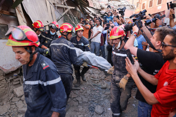 Emergency workers carry a dead body, in the aftermath of a deadly earthquake, in Amizmiz, Morocco, on September 10, 2023. (REUTERS)