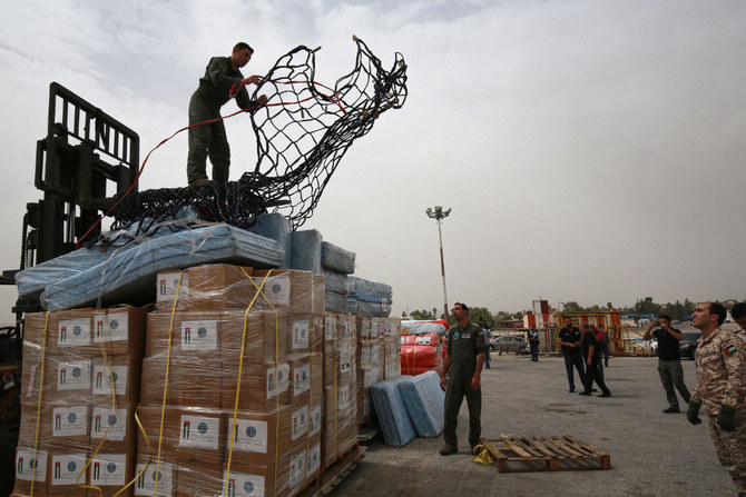 Jordanian soldiers prepare to load humanitarian aid on a plane at the Marka military airport in Amman on September 13, 2023, to be flown to Libya, where devastating flash floods killed at least 5,000 people and displaced at least 30,000 more. (AFP)