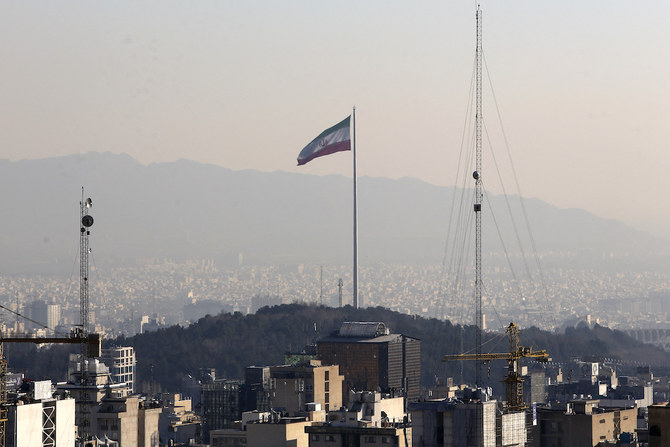 A general view shows the Iranian capital Tehran on Jan. 7, 2023, with the Iranian flag fluttering in the wind. (AFP)