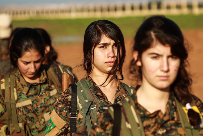 Fighters from the Kurdish women's protection units (YPJ) attend the funeral of an Arab fighter of the Syrian Democratic Forces (SDF) in the town of Tal Tamr in the countryside of Syria's northeastern Hasakeh province on December 21, 2018, after he was killed while fighting against the Daesh group in Hajin in Deir Ezzor province. (AFP)