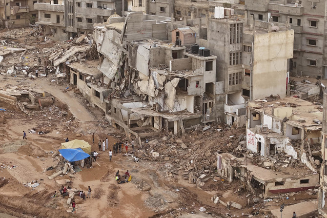 Derna flood survivor Abdul Salam Anwisi said he woke up at one-thirty in the morning to a loud scream from outside, to find his neighbours' homes flooded with water. He, his sons and other neighbours rushed to rescue the stranded families by pulling them from the roof of their house.(AP)