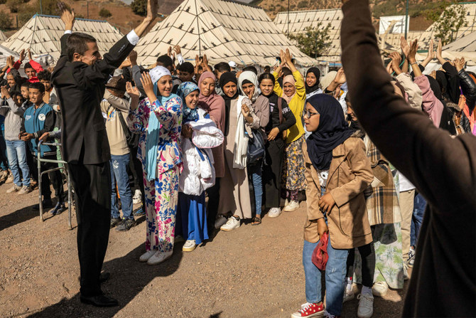 Students attend an assembly outside classroom tents at a make-shift school in the earthquake-hit village of Asni in al-Haouz province in the High Atlas mountains of central Morocco on September 18, 2023. (Fadel Sena/AFP)