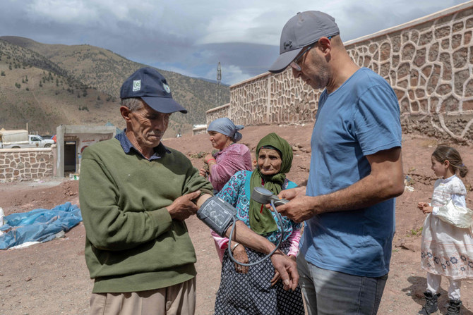A medic checks-up displaced people in a school between Marrakech and Taroudant in the Atlas mountain range on September 17, 2023, in the aftermath of a powerful earthquake. (Bulent Kilic/AFP)