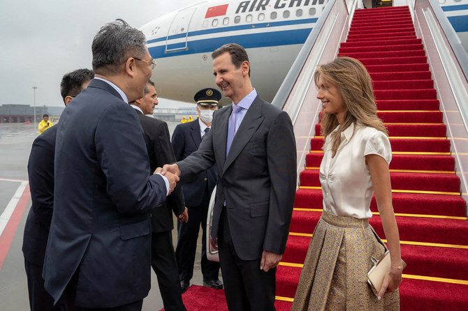 A handout picture released by the official Syrian Arab News Agency shows Syria's President Bashar Assad (C) and wife Asma being welcomed upon their arrival at Hangzhou airport in Beijing, China, on September 21, 2023. (SANA via AFP)