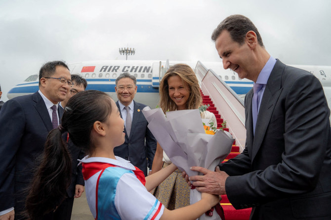 Syria's President Bashar al-Assad and his wife Asma are welcomed upon their arrival at Hangzhou airport, China, September 21, 2023. (SANA/Handout via REUTERS)