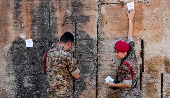 Lebanese Army investigators inspect bullet holes and collect forensic evidence next to the entrance of the US Embassy in Aukar, a northern suburb of Beirut, Lebanon, Sept. 21, 2023. (AP)