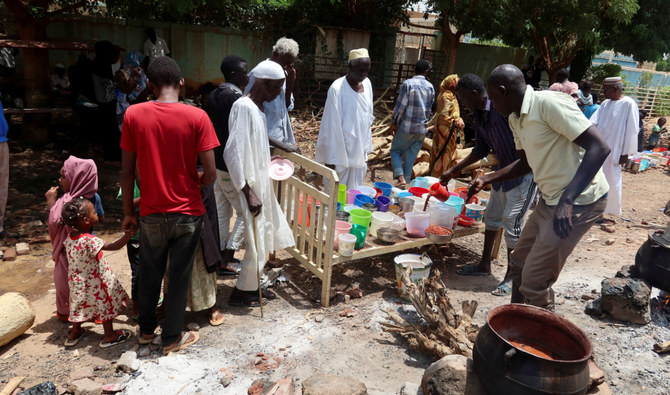 People wait to get food distributed by volunteers in Omdurman, Sudan, September 3, 2023. (Reuters)