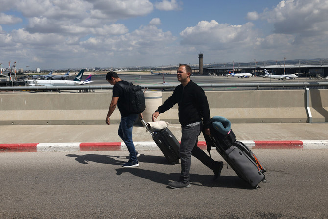 Travellers walk towards the departures area of Ben Gurion Airport near Tel Aviv, on March 9, 2023. (AFP)