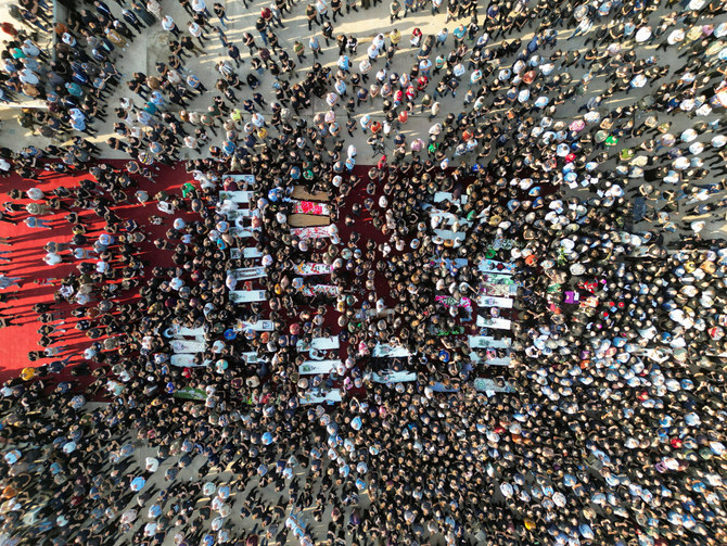 People attend the funeral of victims of the fatal fire of a wedding celebration, in Hamdanya, Iraq, on September 27, 2023. (REUTERS/Abdullah Rashid)