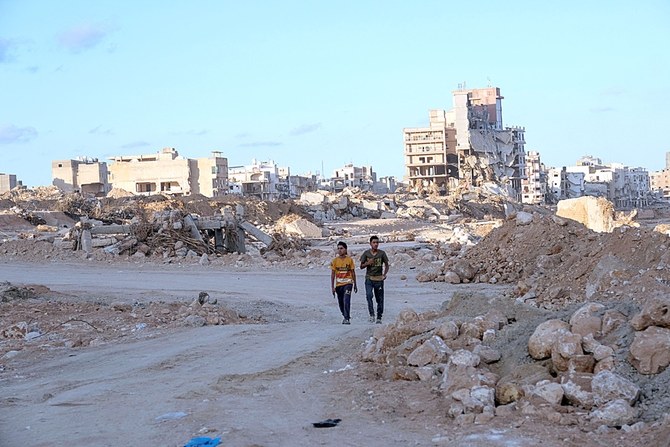 Boys walk down a street impacted by fatal floods in Derna, Libya. (Reuters)