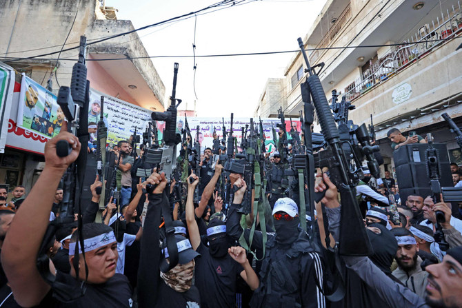 Palestinian militants from the Balata Brigade gather during a memorial rally in the refugee camp of Balata near the West Bank city of Nablus on September 29, 2023 marking the death anniversary of Mohammed Abu Asab, who was killed by Israeli security forces. (AFP)