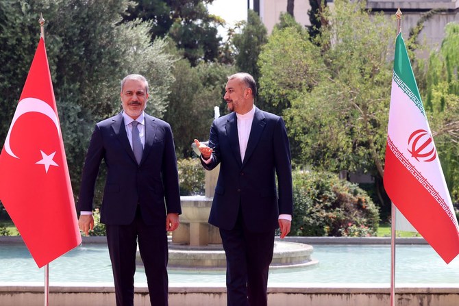 Iran’s Foreign Minister Hossein Amir-Abdollahian welcomes his counterpart from Turkiye Hakan Fidan (L) in Tehran on September 3, 2023. (AFP)