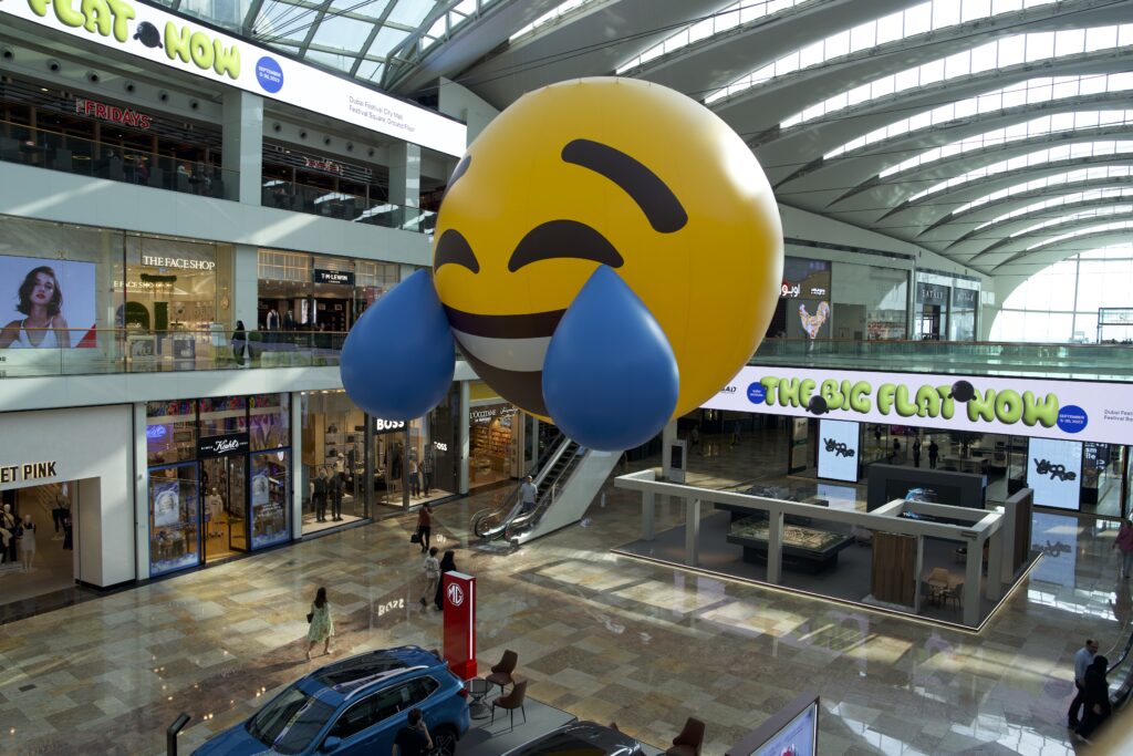 Standing 7 meters tall, The Big Flat Now is a massive emoji balloon, featuring a 3D reproduction of the popular the Face with Tears of Joy emoji. (Supplied)