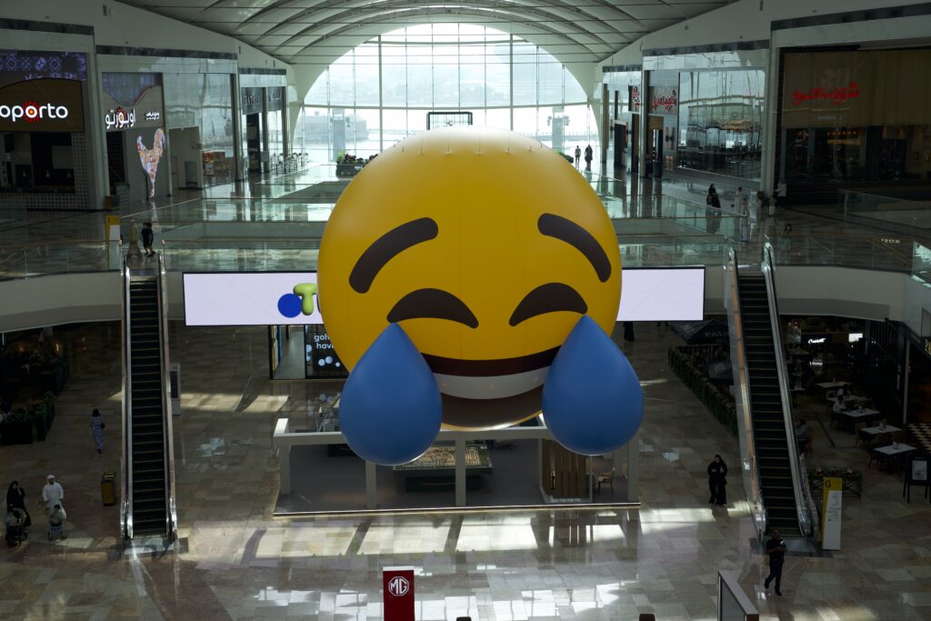Standing 7 meters tall, The Big Flat Now is a massive emoji balloon, featuring a 3D reproduction of the popular the Face with Tears of Joy emoji. (Supplied)
