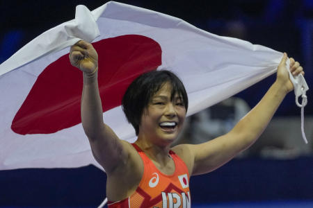 Japan's Akari Fujinami celebrates her victory over Belarus' Vanesa Kaladzinskaya in the Women's 53kg freestyle final during the World Wrestling Championships in Belgrade. (AFP)